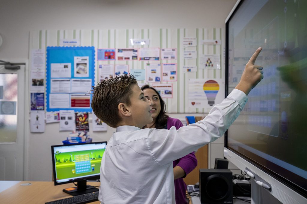 student looking at a smart board