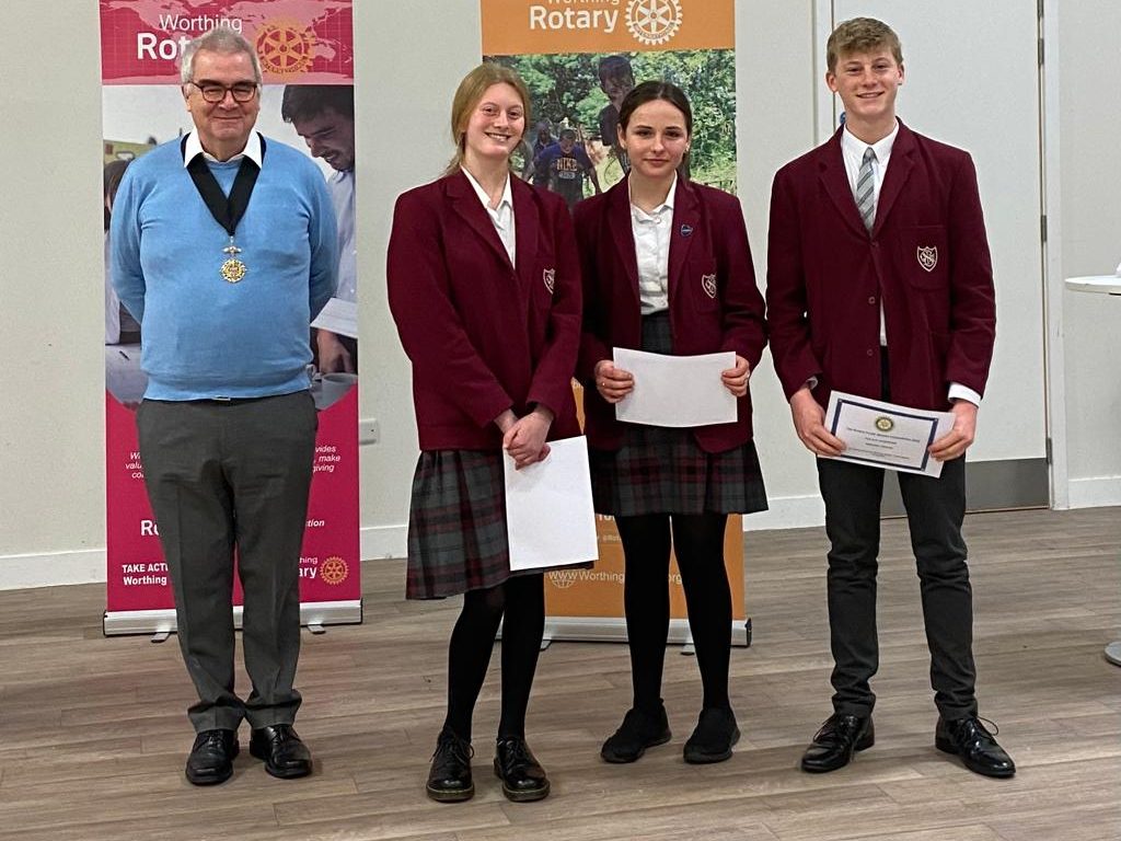 3 students and a member of the rotary club