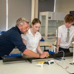 Students and teacher in science class