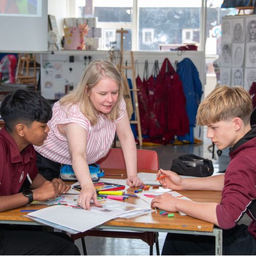 Teacher showing school children classwork