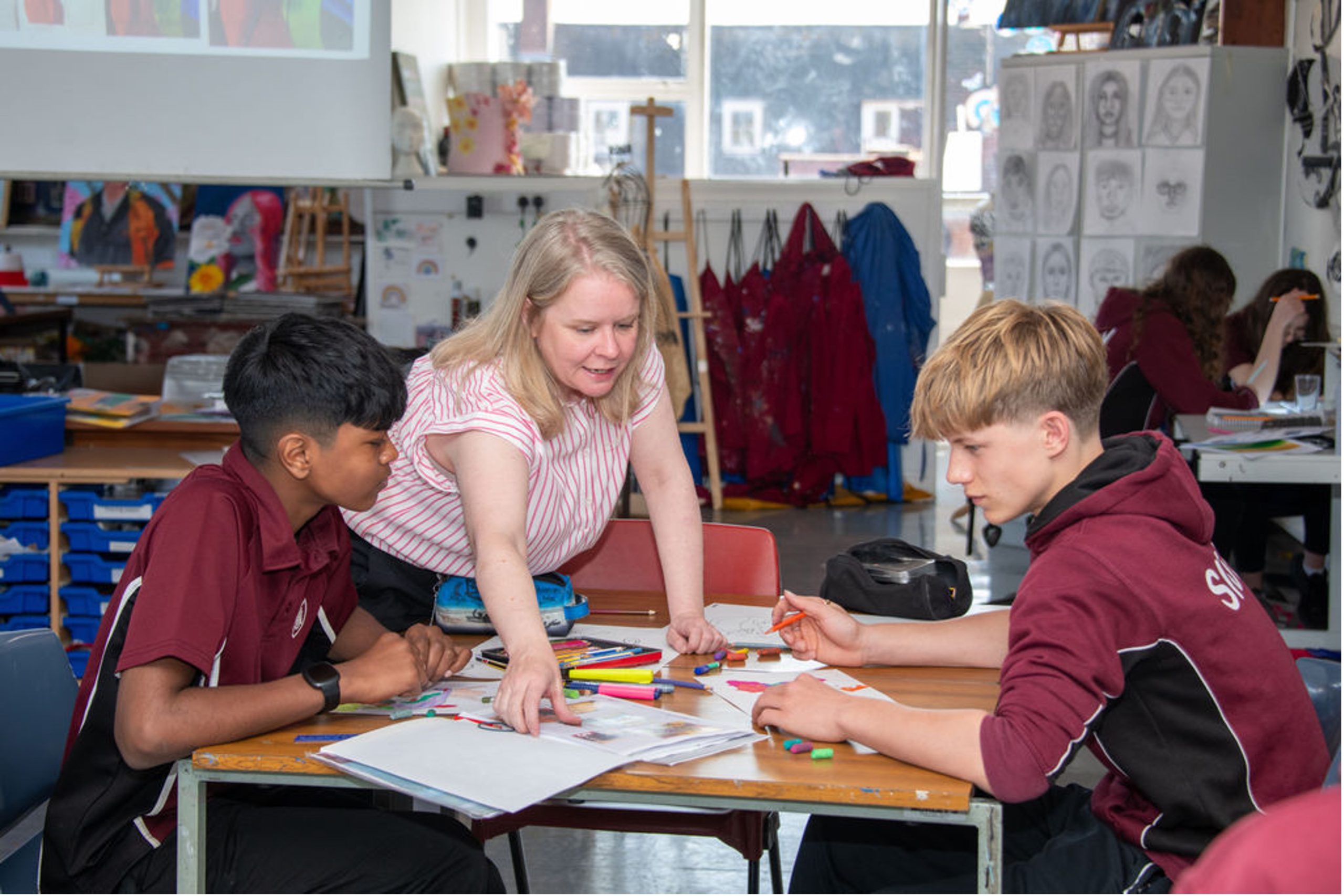 Teacher showing school children classwork